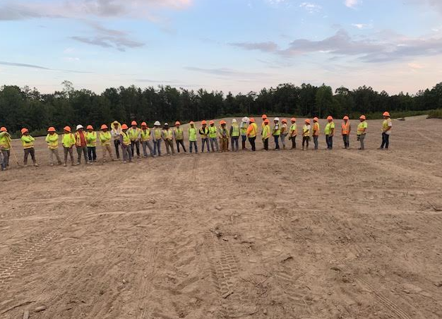 HGS Contracting crew members lined up on a job site