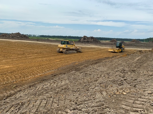 Dozer and padfoot compactor performing mass grading and earthwork